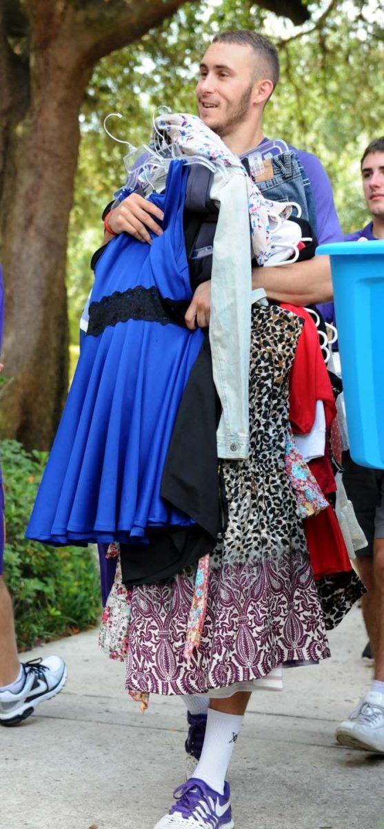 LSU basketball player Keith Hornsby carries a student's dresses during move in day Wednesday August 20, 2014.