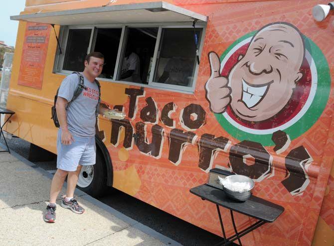 LSU communication studies senior Jacob Larpenteur orders from the first on campus food truck, Taco Churro's, outisde the Journalism building on Monday August 25, 2014.