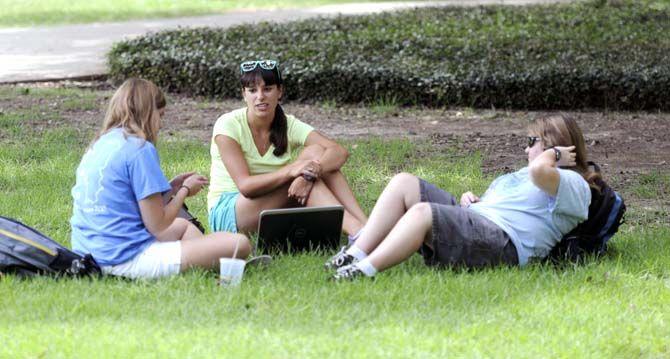 Students relax in the grass of the Quad Monday, August 25, 2014 during the first day of the fall semester.