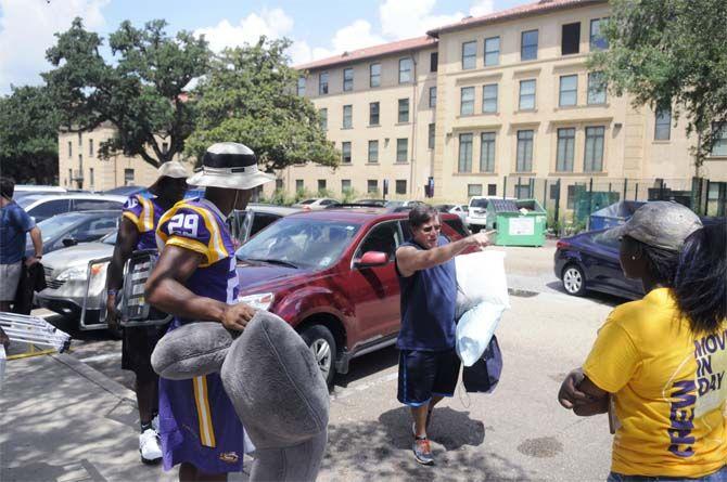 LSU sophomore defensive back Tre'Davious White (16) and sophomore saftey Rickey Jefferson (29) assist students move into their dorms Wednseday August 20, 2014 outside West Hall.