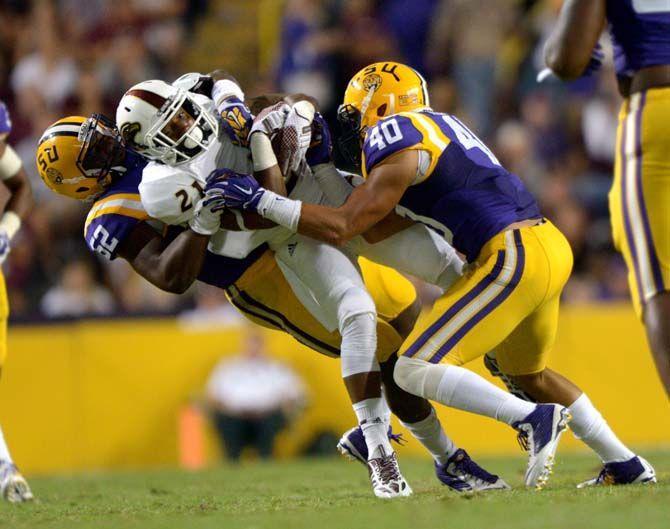 LSU sophomore line backer Kendell Beckwith tackles ULM player Saturday, Sep. 13, 2014 during the Tigers' 31-0 victory against Warhawks in Tiger Stadium.