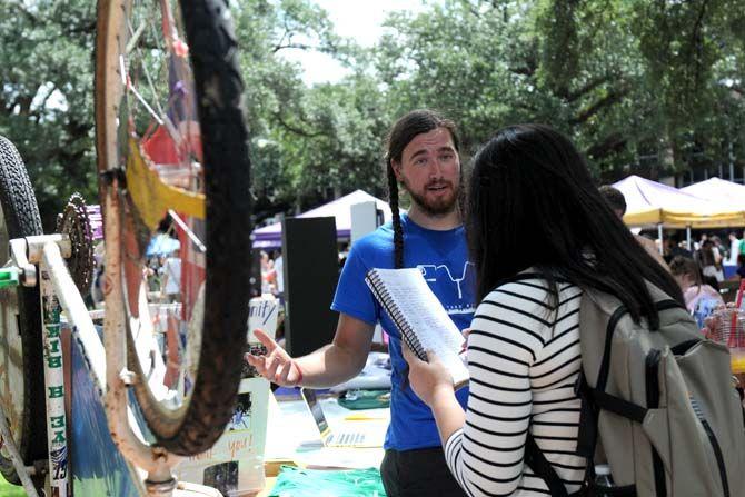 Dustin Lafont of Front Yard Bikes talks to a student at the LSU Student Involvement Fair Wednesday, September 3, 2014.