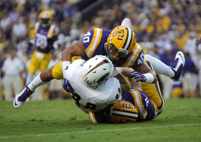 LSU sophomore line backer Duke Riley tackles ULM player Saturday, Sep. 13, 2014 during the Tigers' 31-0 victory against the Warhawks in Tiger Stadium.