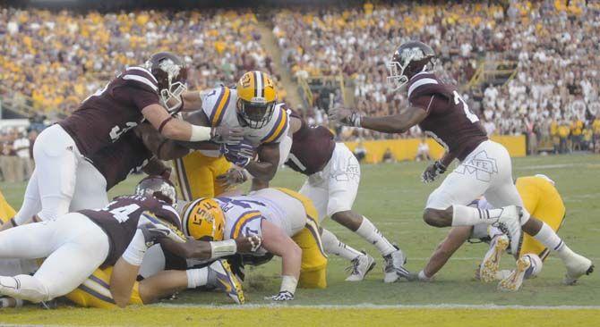 LSU freshman running back Leonard Fournette (7) gets tackled by Mississippi State players in Tiger Stadium on Saturday September 20, 2014 where LSU lost 34-29.