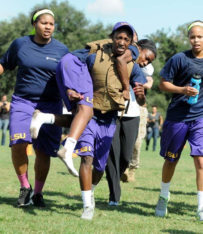 LSU women's basketball freshman forward Stephanie Amichia carries senior guard Dashawn Harden during practice with the marines Friday September 19, 2014 while teammates junior forward Alexis Hyder (left) and freshman guard Jenna Deamer (right) cheer on.