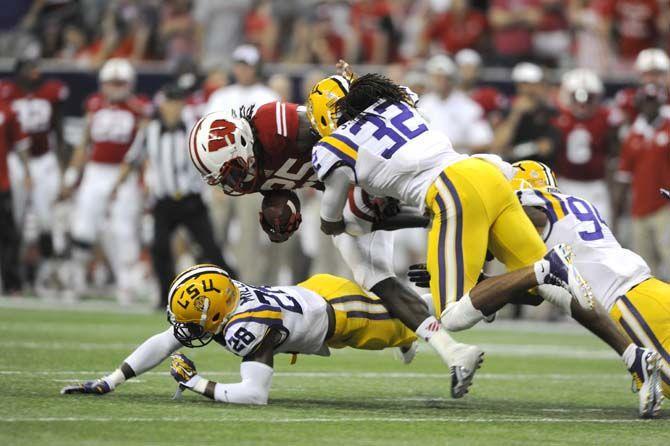 LSU junior corner back Jalen Collins (32) tackles Wisconsin senior running back Melvin Gordon (25) Saturday, August 30, 2014 during the Tigers' 28-24 victory against Wisconsin in the 2014 Advocare Texas Kickoff, held in the NRG Stadium in Houston, Texas.