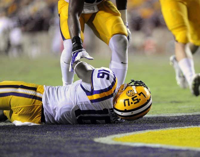 LSU sophomore defensive back Tre'Davious White (16) is helped up by a teammate in Tiger Stadium Saturday, September 20, 2014 in Tigers' defeat 34-29 against Mississippi State University.