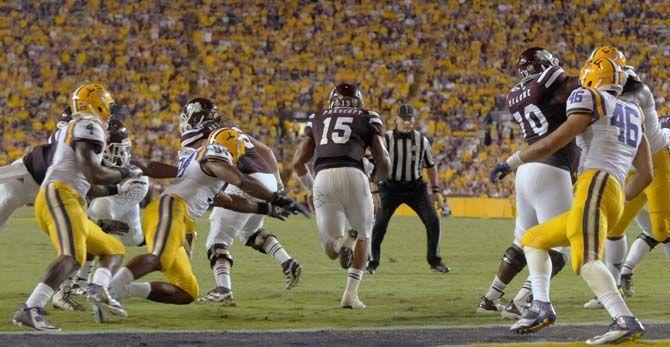 LSU junior defensive end Danielle Hunter (94) attempts to tackle Mississippi State sophmore quarterback Dak Prescott (15) during the game Saturday September 20, 2014 where LSU lost 34-29 in Tiger Stadium.