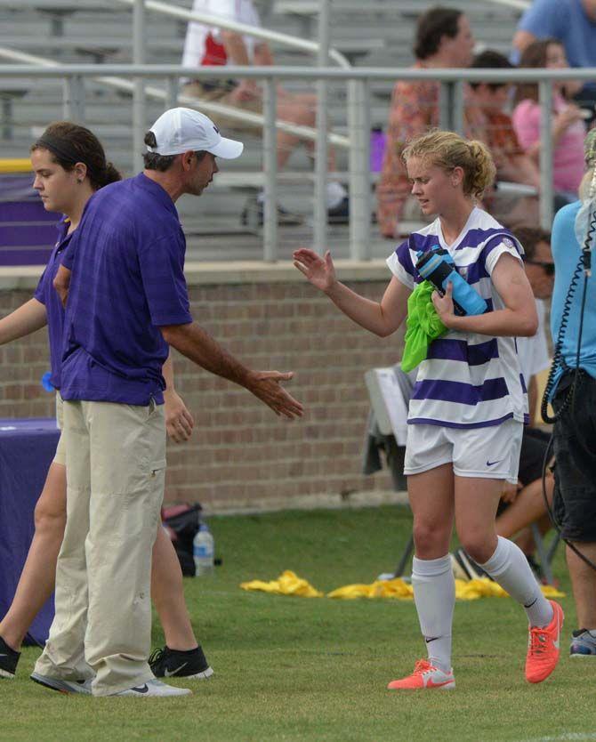 LSU soccer head coach Brian Lee high fives sophomore defender Megan Lee (13) Sunday, September 28, 2014 at LSU soccer stadium where LSU tied to Arkansas 3-3.