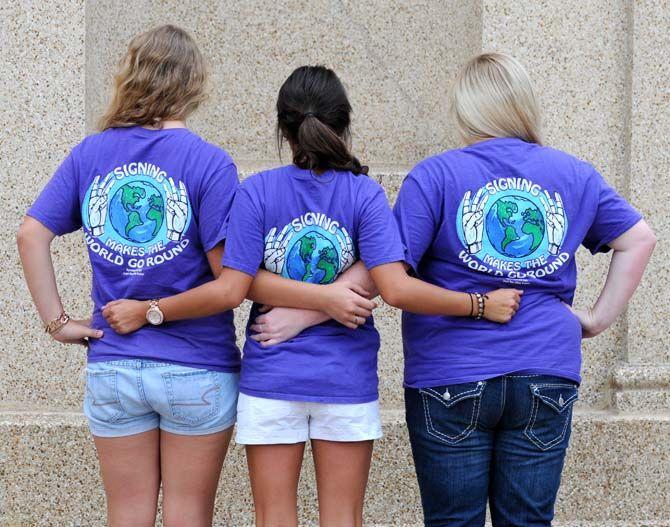 LSU early childhood education junior Lindsey Baker (left), communication disorder senior Lauren Ortego (middle), and communication studies senior Sam Sherwood pose for the Deaf and Hard of Hearing Club.