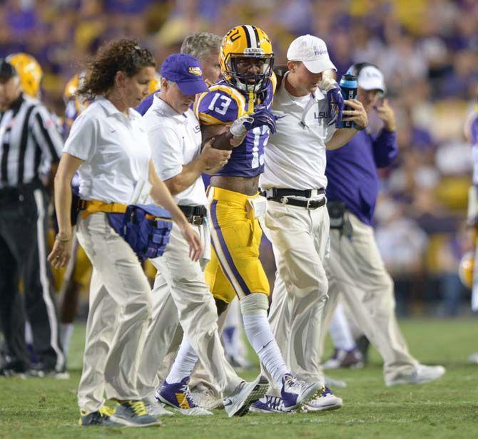 LSU sophomore cornerback Dwayne Thomas is walked off the field after being injured in Tiger Stadium Saturday, September 27, 2014.