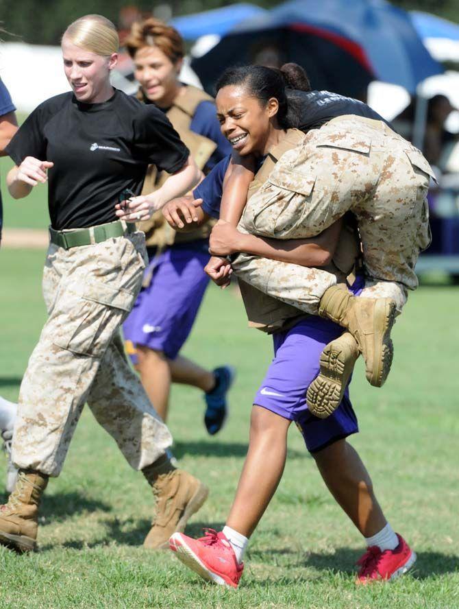 LSU women's basketball junior forward Ann Jones carries a marine druring practice with the marines on Friday September 19, 2014.