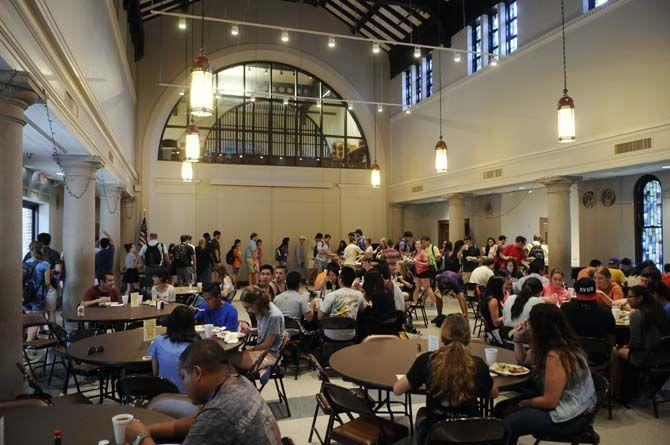 Students enjoy their free lunch probided by Our Lady of Mercy Catholic Church Thursday, September 4, 2014 in Christ the King Catholic Church.