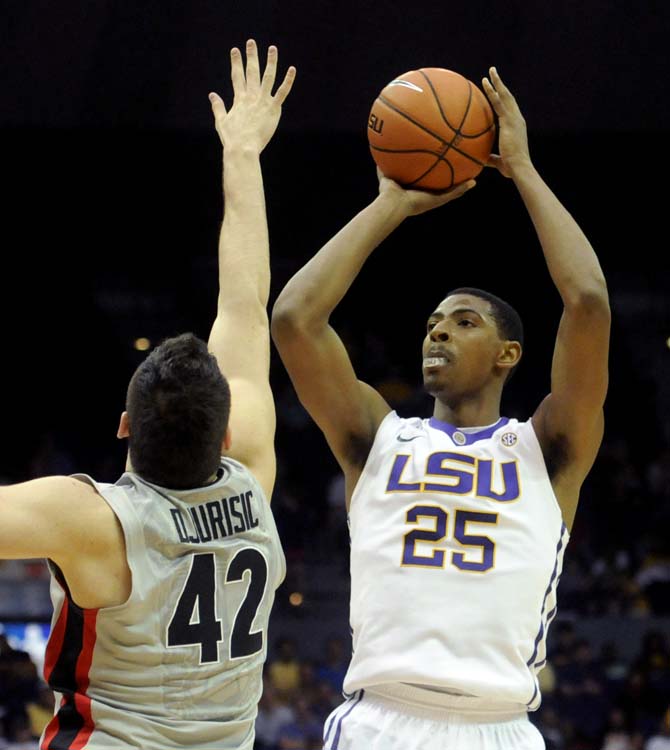 LSU freshman forward Jordan Mickey (25) shoots the ball despite a block from Georgia junior forward Nemanja Djurisic (42) during the Tigers' 61-69 loss to the Bulldogs in the PMAC.