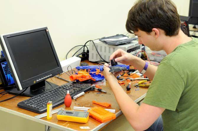 Student works on hand building a project during LSU's first hackathon August 30, 2014.