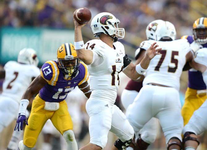 LSU sophomore cornerback Dwayne Thomas (13) prepares to tackle ULM senior quarterback Pete Thomas (14) Saturday, Sep. 13, 2014 during the Tigers' 31-0 victory against the Warhawks in Tiger Stadium.