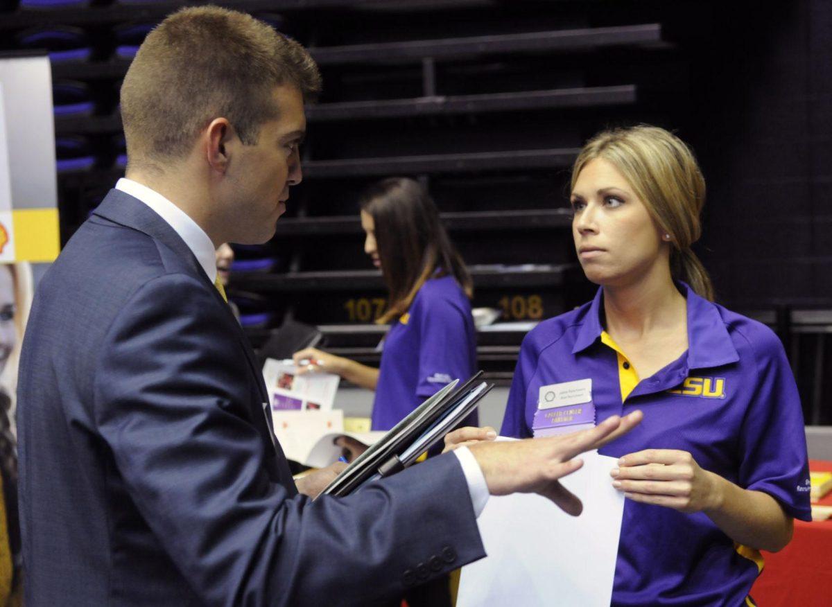 Recruiter Jamie Paternostro, a retail key account manager for Shell Oil Company&#8217;s lubricants division, discusses career possibilities with LSU marketing senior Mark Racioppi Wednesday at the LSU job fair for business and liberal arts majors.