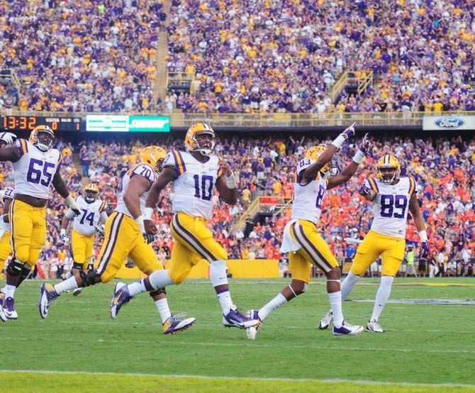 Members of the LSU football team run onto the field Saturday, September 6, 2014 before the Tigers' 56-0 win against Sam Houston State in Tiger Stadium.
