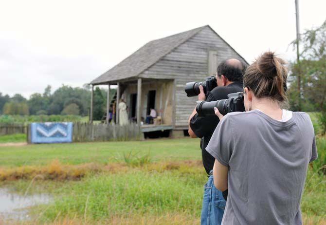 Louisiana Photo Society member Stephanie Ross and President David Arbour photograph on the grounds of the LSU Rural Life Museum during a club field trip Sunday, September 26, 2014.