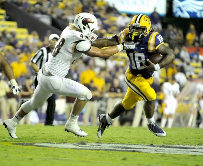 Senior running back Terrance Magee (18) runs for a gain in the Tigers' 31-0 win against ULM on Saturday, September 13th, 2014.