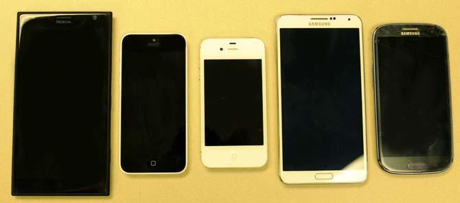 Pictured are the Nokia Lumia 1520 (left), iPhone 5c, iPhone 4, Samsung Galaxy Note 3 and Samsung Galaxy S3 (right).