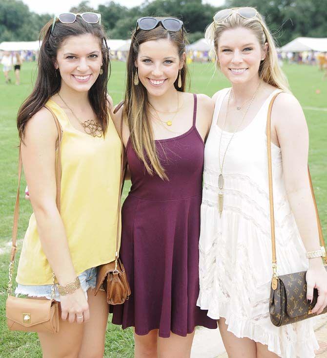 Kinesiology junior Fallen Walters, nursing junior Jeanna Signorelli and nursing junior Paigs Egan pose in their gameday outfits Saturday, September 13, 2014 before the LSU vs ULM football game in Tiger Stadium.