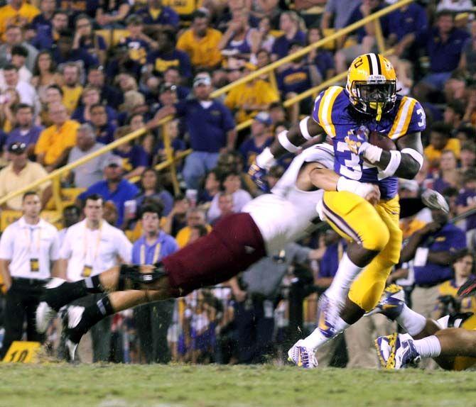 LSU freshman running back Darrel Williams escapes a tackle from NMSU player Saturday, September 27, 2014 during the Tigers' 63-7 victory against the Aggies in Tiger Stadium.