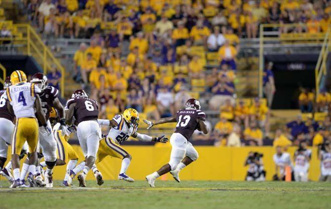 Mississippi State running back Josh Robinson (13) runs down the field avoiding LSU junior starter Jalen Mills (28) in Tiger Stadium Saturday, September 20, 2014 in Tigers' defeat 34-29 against Mississippi State University.