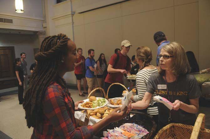 Students enjoy their free lunch probided by Our Lady of Mercy Catholic Church Thursday, September 4, 2014 in Christ the King Catholic Church.