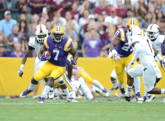 LSU freshman running back Leonard Fournette (7) attempts to evade a ULM defender Saturday, Sep. 13, 2014 during the Tigers' 31-0 victory against the Warhawks in Tiger Stadium.