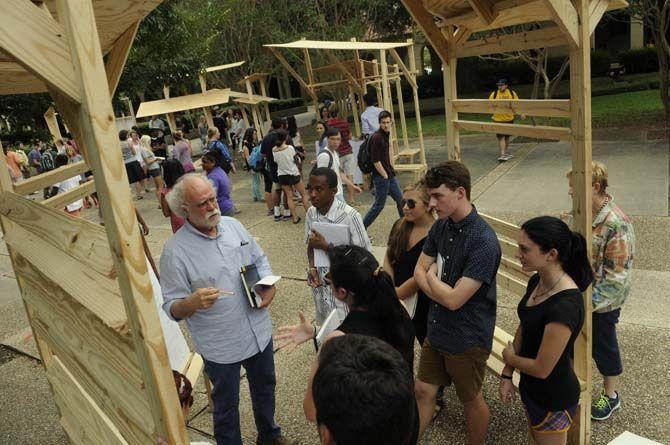 LSU architecture professor Greg Watson evaluates student-built structures Monday, September 8, 2014 in the quad.