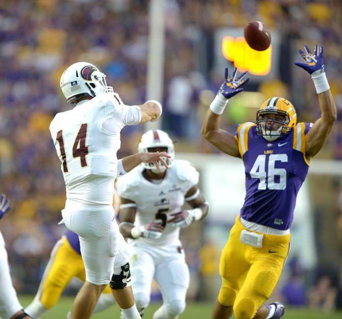 LSU sophomore defensive end Tashawn Bower (46) leaps to block a pass from ULM senior quarterback Pete Thomas (14) Saturday, Sep. 13, 2014 during the Tigers' matchup against the Warhawks in Tiger Stadium. The Tigers lead the Warhawks 10-0 at halftime.