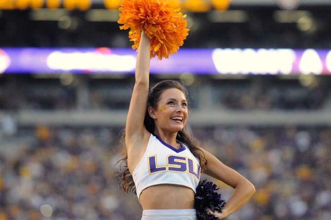 A member of LSU's cheerleading squad pumps up the crowd Saturday, September 27, 2014 during the Tigers' 63-7 win against NMSU in Tiger Stadium.