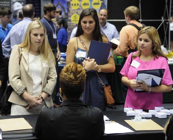 Lsu accounting junior Kristin Kern, marketing junior Laura Johnson and general business junior Abigail Hooley explore the variety of career opportunities offered at LSU job fair on Wednesday, September 10, 2014 in the PMAC.