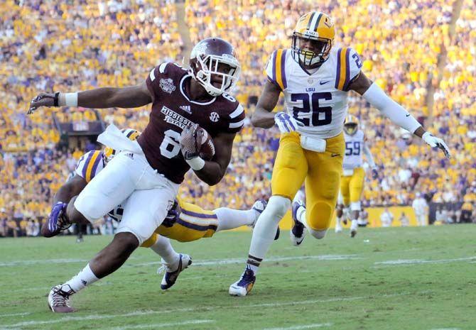 Mississippi State senior tight end Malcolm Johnson (6) outruns LSU senior safety Ronald Martin (26) on Saturday September 20, 2014 where LSU lost 34-29 in Tiger Stadium.