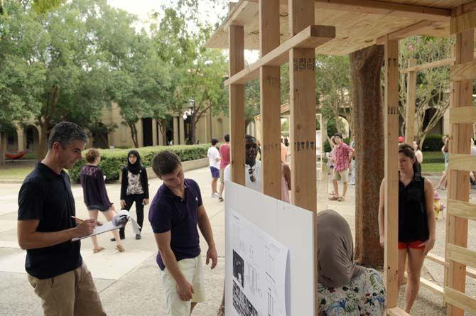 LSU architecture proffesor Robert Holton evaluates student built structures Monday, September 8, 2014 in the quad.