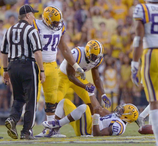 LSU freshman running back Leonard Fournette (7) helps sophmore quarterback Anthony Jennings (10) up from the field during the Mississippi State game in Tiger Stadium on Saturday September 20, 2014 where LSU lost 34-29.