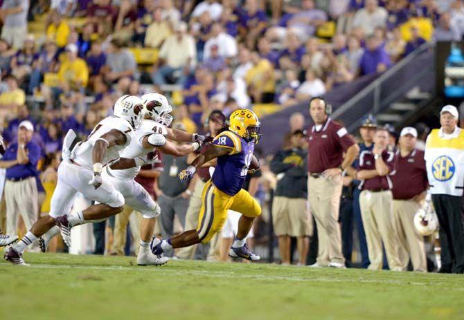 Senior running back Terrance Magee (18) runs for a gain during the Tigers' 31-0 victory against ULM on Saturday, September 13th, 2014.