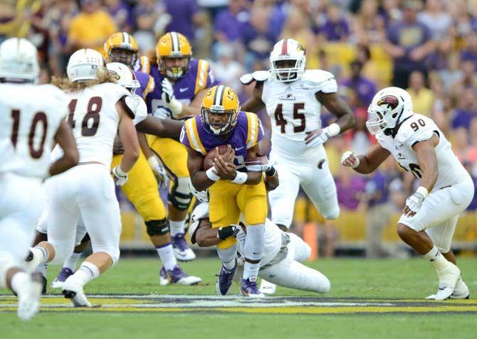 LSU sophomore quarterback Anthony Jennings (10) tucks the football at the end of a run Saturday, Sep. 13, 2014 during the Tigers' 31-0 victory against ULM in Tiger Stadium.