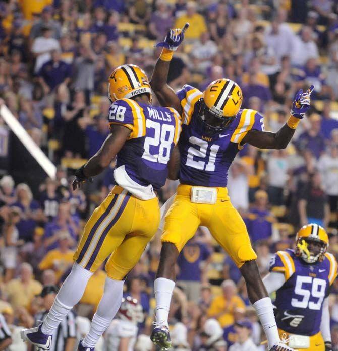 LSU sophomore defensive back Rashard Robinso (21) and junior safety Jalen Mills (28) celebrate a play in Tiger Stadium in winning game 63-7 against New Mexico State on Saturday, September 27, 2014.