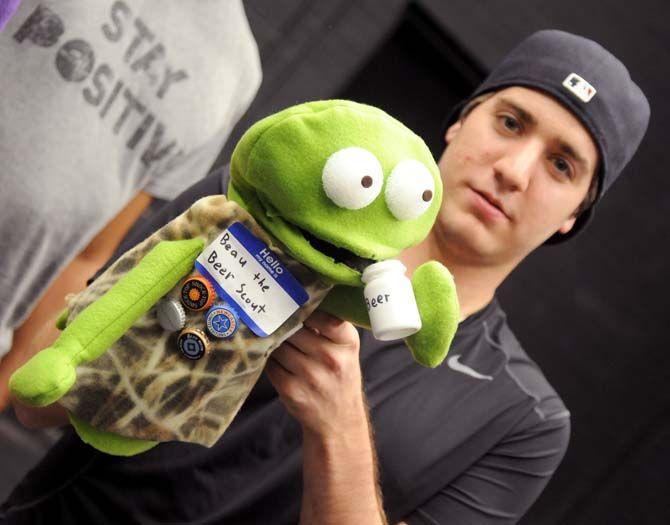 Interdisciplinary studies senior Jason Duhe' poses with puppet "Beau the Beer Scout" that he made in Communication Studies 3900 in Black Box Theatre.