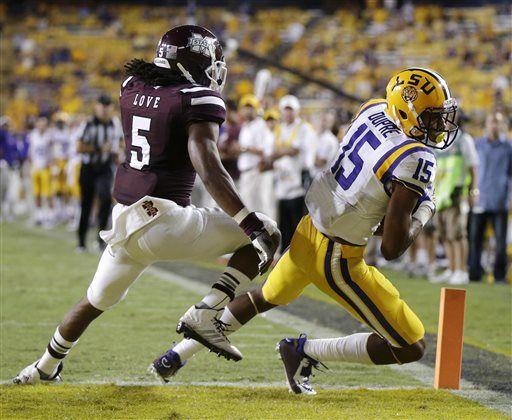 LSU wide receiver Malachi Dupre (15) pulls in a touchdown reception in front of Mississippi State defensive back Jamerson Love (5) to pull within five points in the second half of an NCAA college football game in Baton Rouge, La., Saturday, Sept. 20, 2014. Mississippi State won 34-29. (AP Photo/Gerald Herbert)