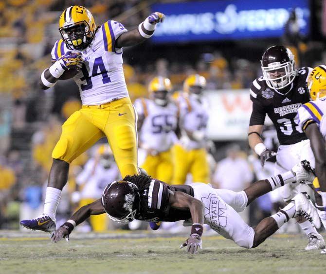 LSU freshman running back Darrel Williams (34) narrowly avoids a tackle from Mississippi State senior defensive back Jamerson Love (5) during the game Saturday September 20, 2014 where LSU lost 34-29 in Tiger Stadium.