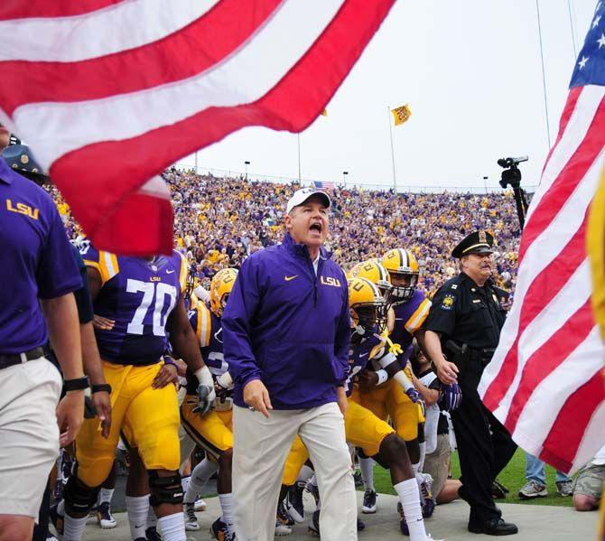 LSU head coach Les Miles leads his team out of the locker room Saturday, Sep. 13, 2014 before the Tigers' 31-0 victory against ULM in Tiger Stadium.