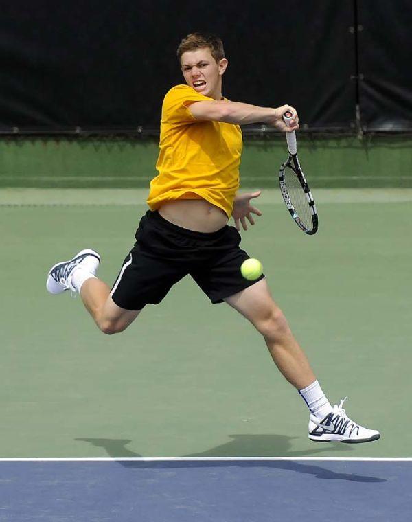 LSU junior Chris Simpson returns a volley Sunday, March 30, 2014 during the Men's Tennis doubles match against Florida at W.T. "Dub" Robinson Stadium.