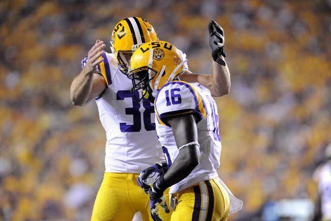 LSU junior punter Jamie Keehn (38) celebrates a successful play with sophomore defensive back Tre'Davious White (16) in game against Mississippi State in Tiger Stadium Saturday, September 20, 2014.