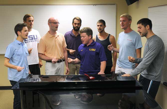 Members of the Tiger Tenors gather around the piano and sing during their practice Sunday, September 7, 2014.