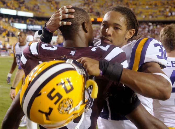 LSU junior cornerback Jalen Collins (32) embraces Mississippi junior cornerback Traveze Calhoun after losing the game 34-29 in Tiger Stadium Saturday September 20, 2014.