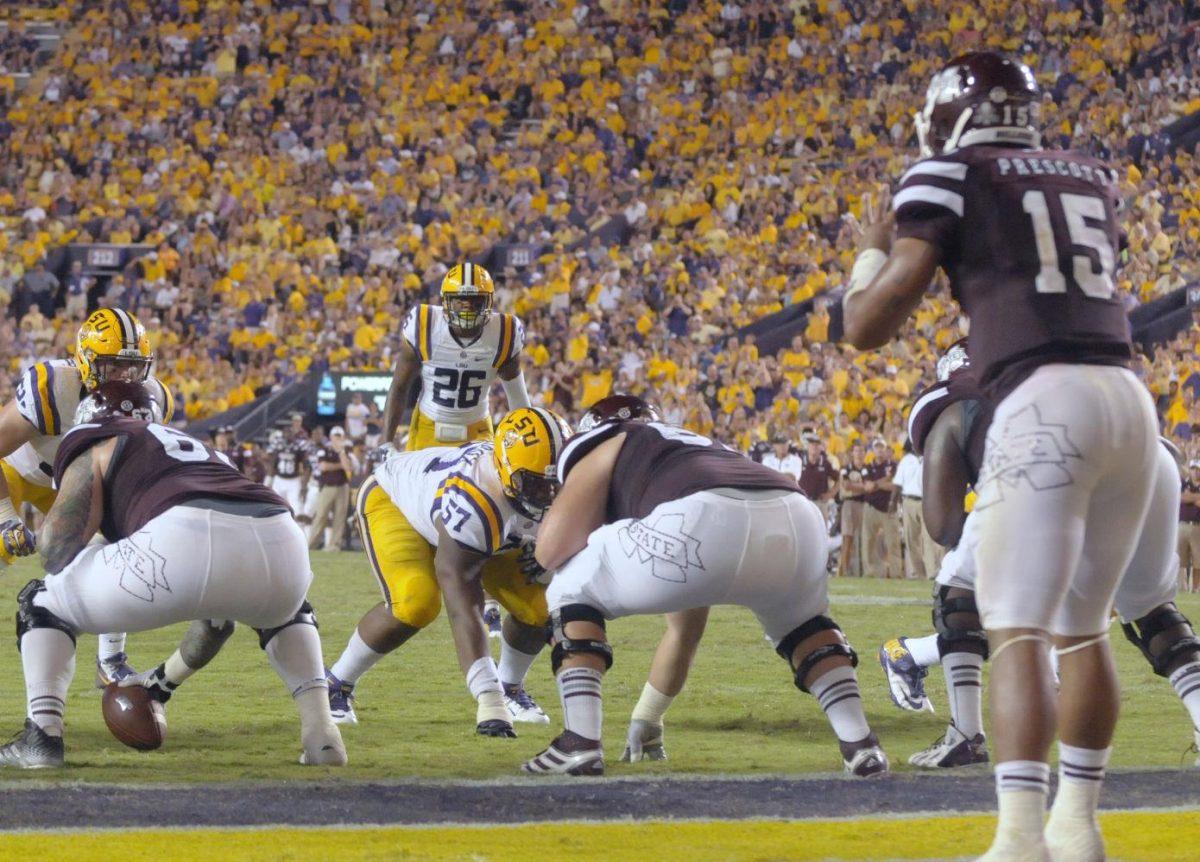 LSU senior safety Ronald Martin (26) from White Castle, La. stares down Mississippi State sophomore quarterback Dak Prescott (15) during the game Saturday September 20, 2014 where LSU lost 34-29 in Tiger Stadium.