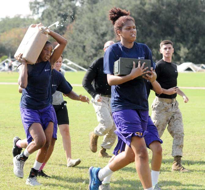 LSU women's basketball senior forward Sheila Boykin (left) and freshman center/forward Alliyah Fareo (right) carry supplies for a practice run by marines Friday September 19, 2014.